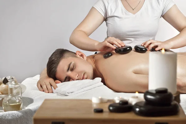 Girl White Shirt Doing Massage Guy Candles Stones Massage Foreground — Stock Photo, Image