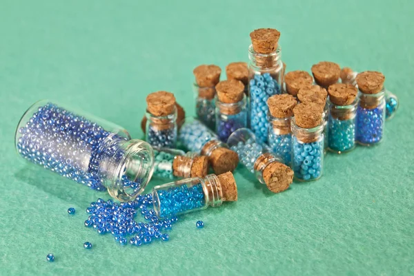Blue Green Purple Beads Glass Jars Bright Cyan Background Beads — ストック写真
