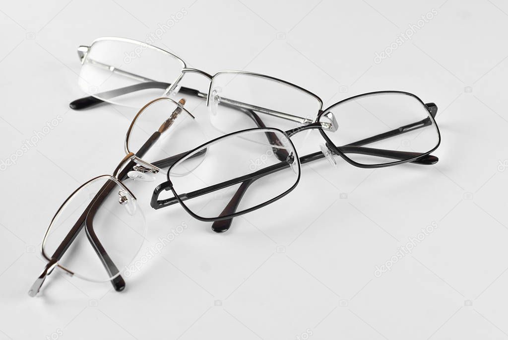 Glasses on a white background. Rectangular glasses in different frames. Three pairs of glasses.