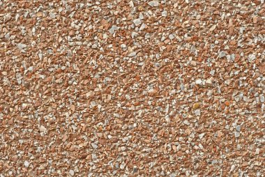 Duvarın dokusu küçük turuncu ve beyaz taşlardan yapılmıştır..