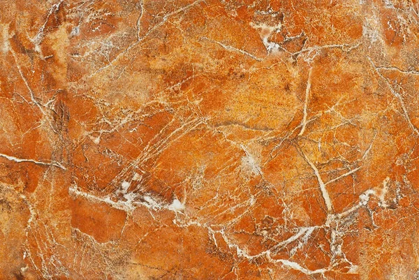 Texture of yellow and orange marble. Stone tile with natural pattern. Marble pavement closeup.