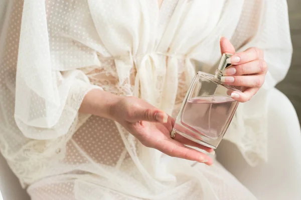 Perfume in a woman`s hand