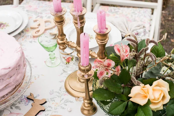 Pink candles in candlestick on the table — Stock Photo, Image