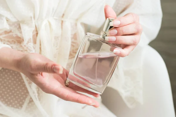 Perfume in a woman`s hand