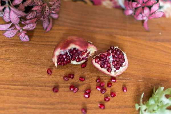 Pomegranate on a wooden table — Stock Photo, Image