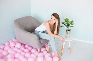 Delikli gri tekli oturan beyaz singlet ve mavi kot modeli.