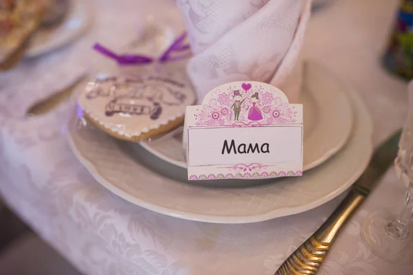 Wedding name place card lying on a white plate