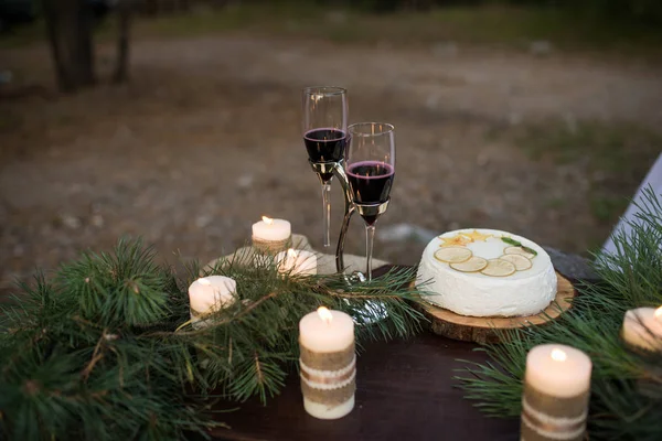 Two Glass Red Wine Wedding Cake Lot Candles Decorated Pine — Stock Photo, Image