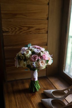 Düğün buket pembe Şakayık, sarı güller ve yeşillik zarif gelin ayakkabıları ile. Aksesuar. 