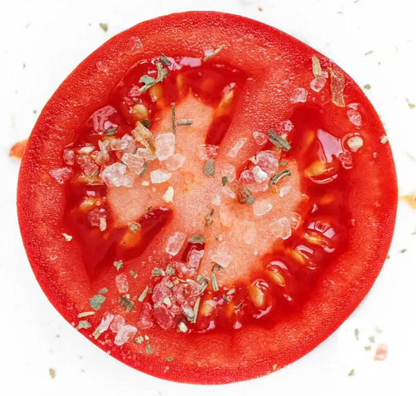 ring of tomato with spices and herbs on white background