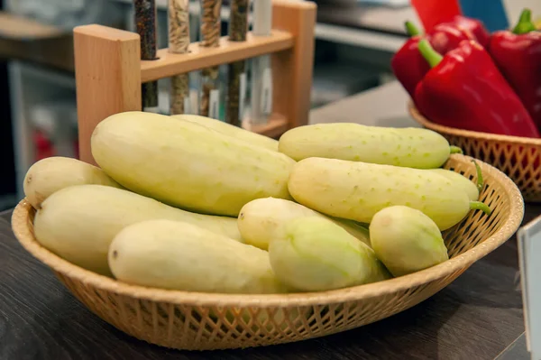 Fresh crisp spiky white cucumbers lie in a basket in the window of the farmer\'s market. Elite modern varieties and hybrids of vegetables