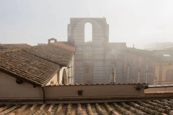 Incomplete facade of the planned Duomo nuovo or Facciatone in fog. Siena. Tuscany Italy. — Stock Photo, Image