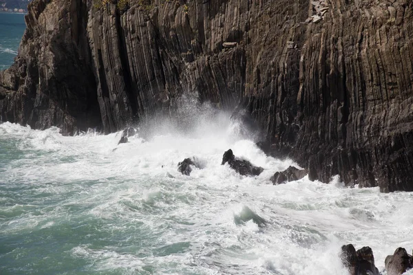 Волна падает на острые камни. Морской пейзаж . — стоковое фото