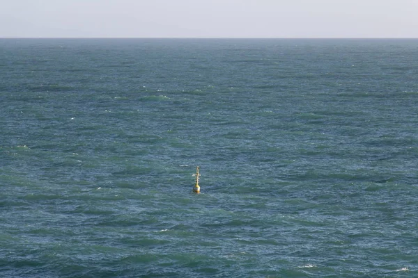 Horizon line over sea and buoy. Seascape.