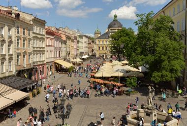 Crowds of tourists on Rynok Square in Lviv. clipart