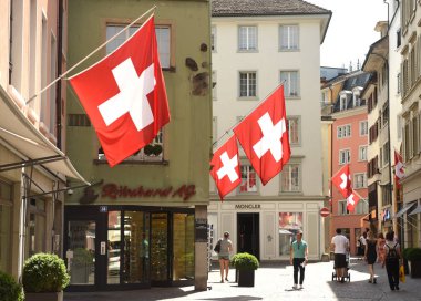 Swiss Flags on the facade building in historic city center of Zurich, Switzerland. clipart