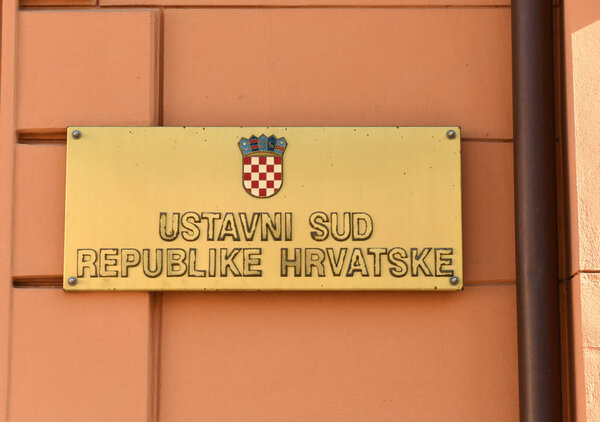 The sign reads Croatian Constitutional Court (Ustavni sud Republike Hrvatske) on building Croatian Constitutional Court in Zagreb.