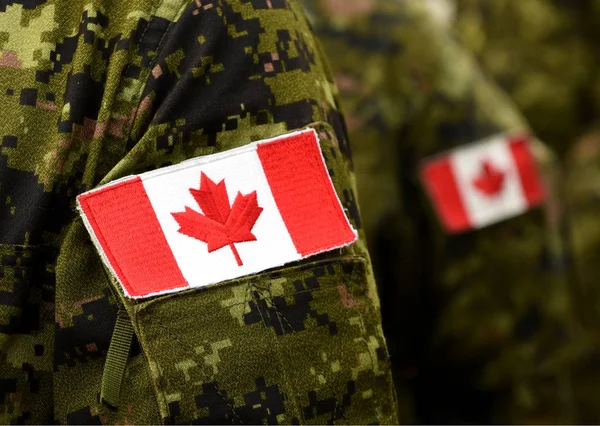 Flag of Canada on military uniform. Canadian soldiers. Army of Canada. Remembrance Day. Canada Day.