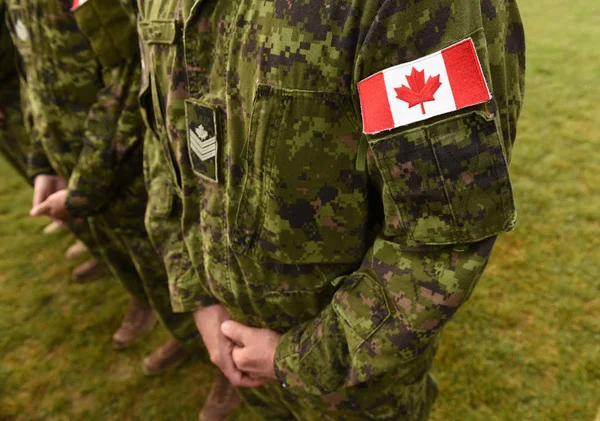 Flag of Canada on military uniform. Canadian soldiers. Army of Canada. Remembrance Day. Canada Day.