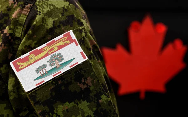 Flag of Prince Edward Island on the military uniform and red Maple leaf on the background. Flag of Canadian province of Prince Edward Island. Canada Day.