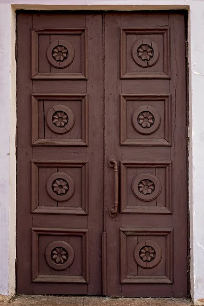 Old brown house door. Wooden vintage building gate weathered. Closed doorway.