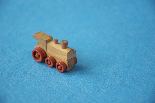 Wooden toy train on a blue background