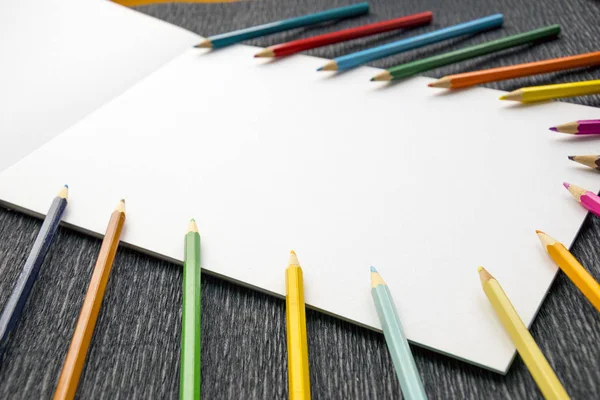 Набір різнокольорових олівців з альбомом для малювання — стокове фото