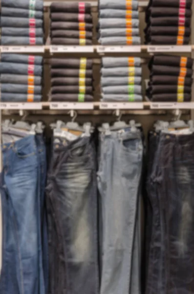 Jeans on shelf in clothing store — Stock Photo, Image
