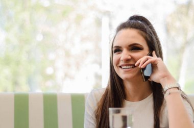 Cep telefonuyla konuşan bir kadın.   