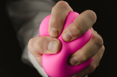 male hand pressing stress ball clipart