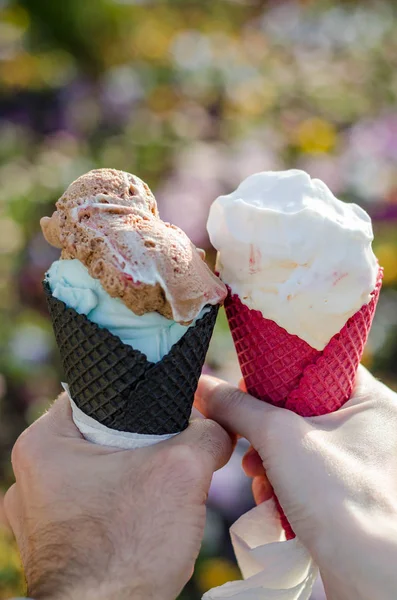 hands with ice cream cones