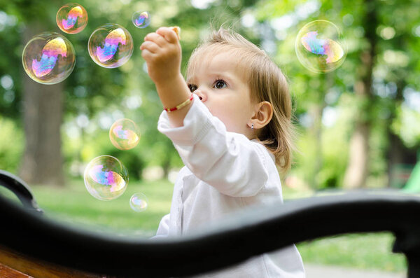 baby playing with soap bubbles