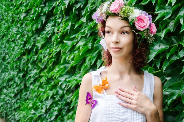 Kvinna med en hel del fjärilar och blommor — Stockfoto