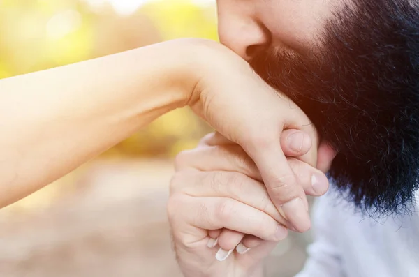 husband kissing hand of his wife