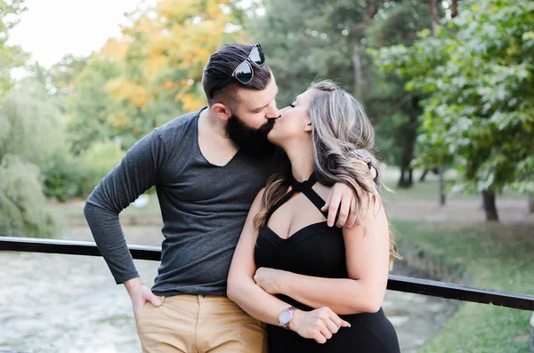 Young happiness marriage couple kissing each other in park — Stock Photo, Image