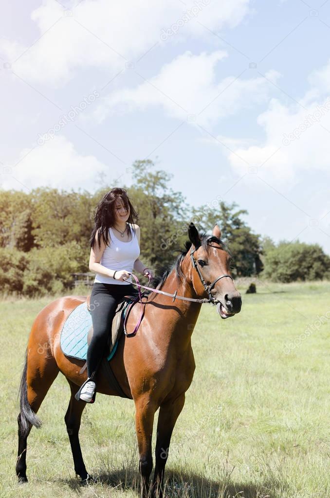 smiling young woman riding horse