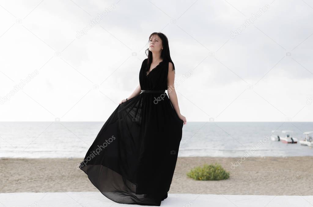 Woman dancing on sea beach