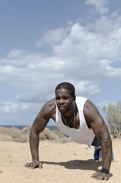 Strength black man doing push up