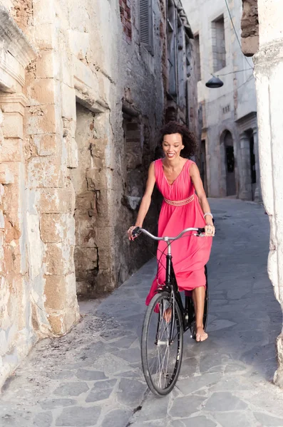 Woman in dress rides bicycle