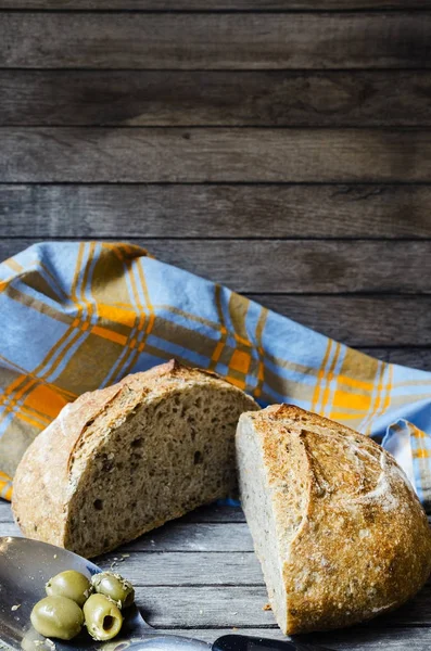 Fresh baked olive bread from oven, Focaccia bread with olives on wooden background