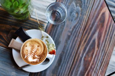 Latte sanat, barista güzel retro ahşap arka plan, Tarih tarafından yapılan kahve sanat yukarıdan görüntüleyin veya top. Metin için yer kopyalayın