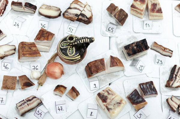 lots of different types of bacon on the table, competition in production and quantity of fat, dried bacon