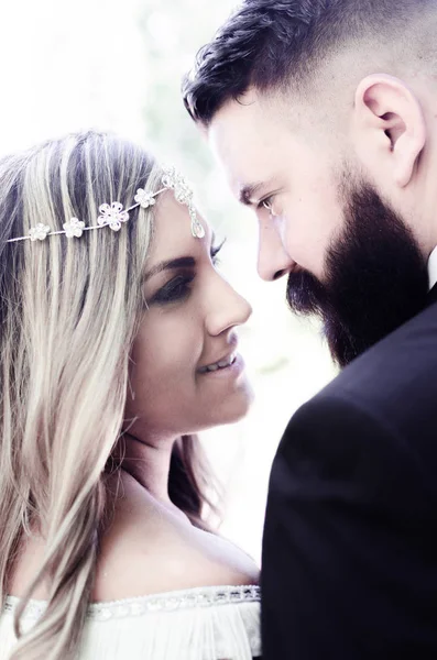 bride next to each other, love, Wedding couple outdoors is hugging each other. Beautiful model girl in white dress. Man in suit. Beauty bride with groom. Female and male portrait. Cute lady and handsome guy with long beard