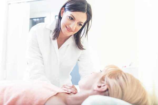 Soothing expression on caring doctors face after done acupuncture treatment