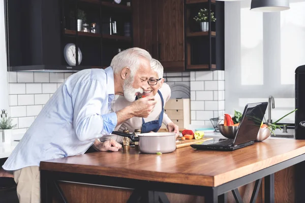 Senior Happy Couple Kitchen Recipes Digital Tablet Man Who Tastes — 스톡 사진