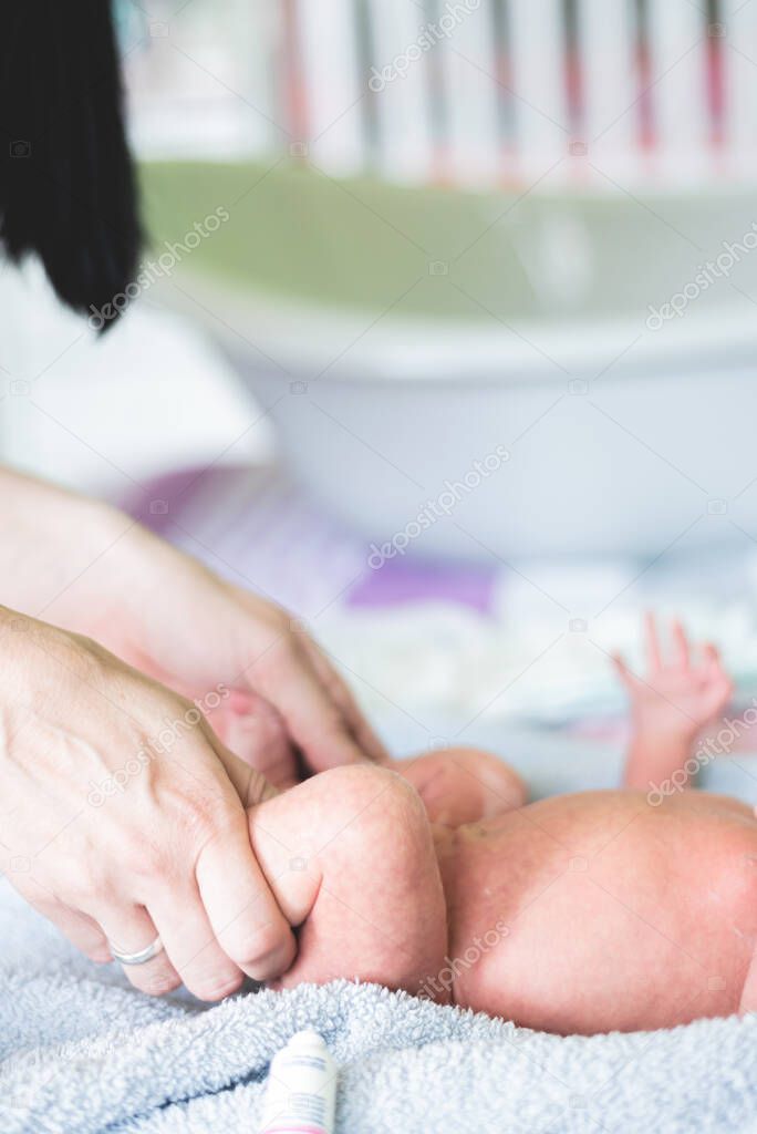 Cropped picture of pediatrician's hands checking baby's reflexes and knees