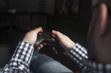 hav rahatlatıcı joypad tutmak ve video oyun, genç bir adam