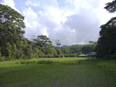 Supply of food by helicopter in the natural park corcovado costa rica america clipart