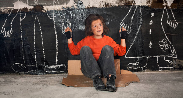 Orphan boy on the street fantasizing about parents