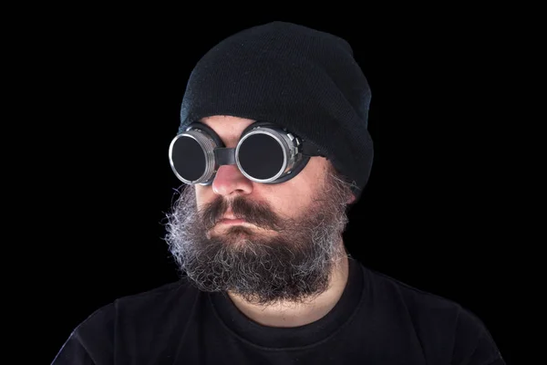 Weird guy with vintage welding goggles on black background